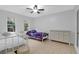 Bright bedroom with ceiling fan and two white beds with a white dresser, all sitting on tile floor at 112 Fox Chase Dr, Goose Creek, SC 29445