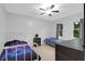 Bright bedroom with ceiling fan and two beds with metal frames, all sitting on tile floor at 112 Fox Chase Dr, Goose Creek, SC 29445