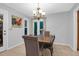 Comfortable dining area with a chandelier, tile flooring, and a view of the backyard at 112 Fox Chase Dr, Goose Creek, SC 29445