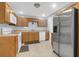 Efficient kitchen featuring wooden cabinets, stainless steel refrigerator, and tile flooring at 112 Fox Chase Dr, Goose Creek, SC 29445