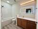 This bathroom features a bathtub with shower, a wood vanity, a sink and a lighted mirror at 1225 Blakeway St # 906, Charleston, SC 29492
