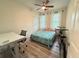 This bedroom boasts an adjacent work area with a desk, a window, and a bed with a floral comforter at 1225 Blakeway St # 906, Charleston, SC 29492
