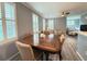 Elegant dining area with wood table, plantation shutters, and stylish flooring at 1225 Blakeway St # 906, Charleston, SC 29492