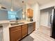 Functional kitchen layout with wood cabinetry, stainless steel appliances, and breakfast bar at 1225 Blakeway St # 906, Charleston, SC 29492