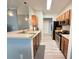 Open kitchen featuring stainless steel appliances, wood cabinets, and laminate floors at 1225 Blakeway St # 906, Charleston, SC 29492