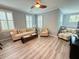 Cozy living room featuring comfortable seating, plantation shutters, and a ceiling fan at 1225 Blakeway St # 906, Charleston, SC 29492