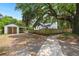 Backyard with a garage, a wooden fence, a mature tree and a walking path at 1248 Sumner Ave, North Charleston, SC 29406