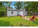 Charming backyard with a cozy fire pit and red Adirondack chairs, perfect for outdoor relaxation and entertaining at 1248 Sumner Ave, North Charleston, SC 29406