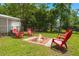 Lush backyard featuring a brick fire pit and Adirondack chairs creating an inviting outdoor living space at 1248 Sumner Ave, North Charleston, SC 29406