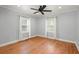 Bedroom featuring hardwood floors, ceiling fan, and two bright windows at 1248 Sumner Ave, North Charleston, SC 29406