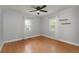 Bedroom with hardwood floors, ceiling fan, two windows with white curtains at 1248 Sumner Ave, North Charleston, SC 29406
