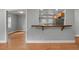 Dining area featuring wood floors and a bar top pass through to kitchen at 1248 Sumner Ave, North Charleston, SC 29406
