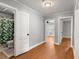 Hallway with hardwood floors and doors leading to the bathroom and bedroom at 1248 Sumner Ave, North Charleston, SC 29406
