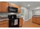 Kitchen featuring wood cabinets, wood floors, and black microwave at 1248 Sumner Ave, North Charleston, SC 29406