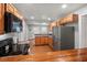 Kitchen featuring stainless steel refrigerator, wood cabinets, and a bar top pass through to dining at 1248 Sumner Ave, North Charleston, SC 29406