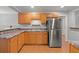 Kitchen with stainless steel refrigerator, wood cabinets, and a laundry area at 1248 Sumner Ave, North Charleston, SC 29406