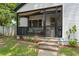 Inviting front porch with black railing, textured plants, and stone stairs at 1248 Sumner Ave, North Charleston, SC 29406