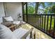 Screened porch featuring chairs, a side table and a yellow rug at 1248 Sumner Ave, North Charleston, SC 29406