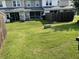 View of a townhome backyard featuring a well-maintained lawn and a wooden privacy fence at 126 Woodward Rd, Goose Creek, SC 29445