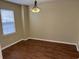 An open dining room featuring warm vinyl flooring and a modern light fixture at 126 Woodward Rd, Goose Creek, SC 29445