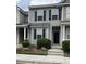 Two-story townhome featuring muted green siding, black shutters, and a well-maintained landscaped front yard at 126 Woodward Rd, Goose Creek, SC 29445