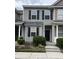 Two-story townhome featuring muted green siding, black shutters, and a well-maintained landscaped front yard at 126 Woodward Rd, Goose Creek, SC 29445