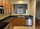 Kitchen with double stainless sink, new dishwasher, stone counters, and warm wood cabinetry at 126 Woodward Rd, Goose Creek, SC 29445