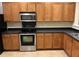 Well-appointed kitchen with stainless steel appliances, granite countertops, and warm wood cabinetry at 126 Woodward Rd, Goose Creek, SC 29445