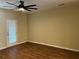 Open living room with hardwood floors, fan, and a door to the backyard at 126 Woodward Rd, Goose Creek, SC 29445