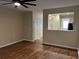 Spacious living room with hardwood floors, fan, and view into the kitchen at 126 Woodward Rd, Goose Creek, SC 29445