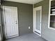 Back patio featuring two doors and green siding at 126 Woodward Rd, Goose Creek, SC 29445