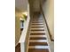 Classic wooden staircase with white risers and balustrade leads to the upper level of the home at 126 Woodward Rd, Goose Creek, SC 29445