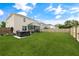Spacious backyard with green lawn, hot tub, and screened-in porch at 1301 Wild Goose Trl, Summerville, SC 29483