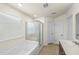 Bright bathroom featuring a large tub with shower, vanity, and modern fixtures at 1301 Wild Goose Trl, Summerville, SC 29483