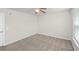 A modest empty bedroom featuring a ceiling fan, neutral paint, and carpet at 1301 Wild Goose Trl, Summerville, SC 29483