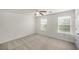 Bright bedroom with two windows, neutral carpeting, and a ceiling fan at 1301 Wild Goose Trl, Summerville, SC 29483