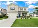Charming two-story home with a well-manicured lawn, blue front door, and an attached two-car garage at 1301 Wild Goose Trl, Summerville, SC 29483
