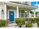 Inviting front porch with a blue door, decorative wreath, and charming seating, creating a welcoming entrance at 1301 Wild Goose Trl, Summerville, SC 29483