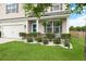 Beautifully landscaped front yard features lush green grass, trimmed hedges, and a pop of color from the blue door at 1301 Wild Goose Trl, Summerville, SC 29483