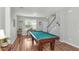Spacious game room features a pool table, wood-look floors, neutral walls, and ample natural light at 1301 Wild Goose Trl, Summerville, SC 29483