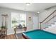 Basement game room featuring a pool table, neutral walls, and natural light filtering through the window at 1301 Wild Goose Trl, Summerville, SC 29483