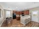 Eat-in kitchen features wood cabinets, breakfast bar, and stainless steel appliances, with adjacent dining area at 1301 Wild Goose Trl, Summerville, SC 29483