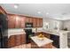 Kitchen features wood cabinets, granite countertops, and stainless steel appliances, creating a modern cooking space at 1301 Wild Goose Trl, Summerville, SC 29483