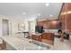 Kitchen with granite countertops, stainless steel sink, island, and wood cabinets, near dining area at 1301 Wild Goose Trl, Summerville, SC 29483