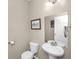 Powder room with pedestal sink, toilet, mirror, and neutral paint at 1301 Wild Goose Trl, Summerville, SC 29483