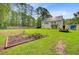 Sprawling backyard with garden beds and plenty of room for outdoor activities at 142 Maxwell Rd, Summerville, SC 29483