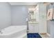 Bright bathroom with tub, white cabinets, and tile floor at 142 Maxwell Rd, Summerville, SC 29483