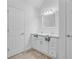 Bright bathroom featuring a double vanity with white cabinets and neutral tile floors at 142 Maxwell Rd, Summerville, SC 29483