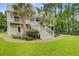 Beautiful home with a metal roof, double porches, mature trees, and lush landscaping, creating curb appeal at 142 Maxwell Rd, Summerville, SC 29483