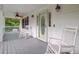 Inviting front porch with rocking chairs, ceiling fan, and decorative glass front door at 142 Maxwell Rd, Summerville, SC 29483